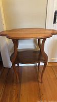full view of two-tier side table showing shape and cabriole legs