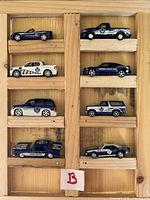 All eight Toronto Maple Leafs themed diecast vehicles arranged in wooden rack