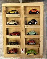 All ten Dinky die-cast cars arranged in wooden display
