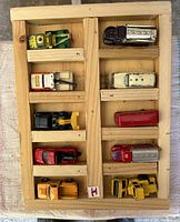 full view of wooden rack with 10 die-cast vehicles