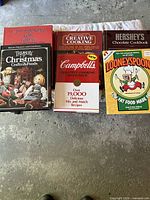 All six cookbooks arranged side by side