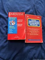 Front covers of Larousse and Webster's dictionaries