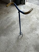 Full view of manual soil turner showing handle, shaft and tines