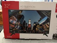 Retail box front displaying RCA 32" HD Television model RT3205-C