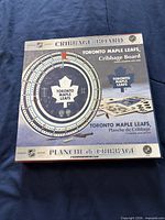 Front of boxed cribbage board showing design and branding