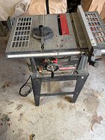 Full view of Craftsman table saw on stand with cord visible