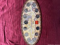 Front view of oval Canada 2000 Millennium coin board showing ten quarters