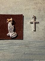 front view of praying hands charm and cross charm