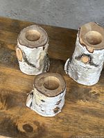 Three birch log tea light holders with drilled cavities