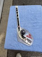 Packaged Tim Hortons Sidney Crosby mini hockey stick with ball displayed on blue surface
