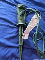 Full view of green stake power bar showing cord and outlets