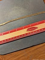 Gold-tone chain bracelet alongside ruler showing roughly 9-inch length