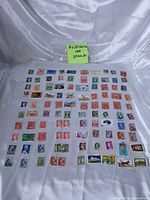 Full layout of 100 assorted Australian stamps on white background with note
