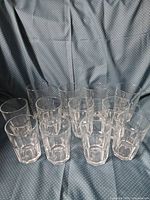 Front view of all 12 clear glass tumblers grouped together