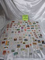 Full layout of all Canadian stamps on cloth backdrop