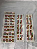 Three uncut strips of 7¢ British Columbia Centennial stamps