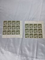 Two partial sheets of 1965 Canada 3¢ Christmas stamps on white surface