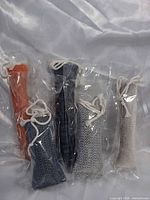 Five sealed woven fabric catnip toys standing upright