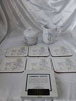 Full lot showing sugar bowl, creamer, six coasters in front of box