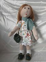 Front view of cloth doll with all accessories visible