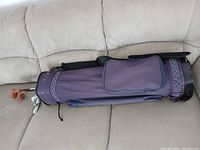 Full view of purple golf bag on couch