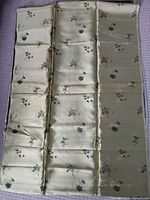 Full view of fabric light gold side showing floral motifs and overall condition