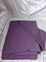 Folded purple fabric on white background showing overall piece