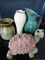 Front view of all four items: Lenox vase, two pitchers, turtle figurine
