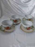 Full set of four cups and saucers displayed