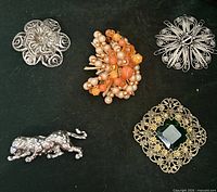 Group shot of all five brooches