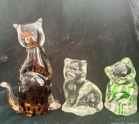 Group shot of three glass cat figurines