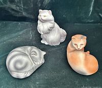 Front view of all three cat figurines