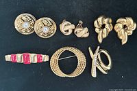 Full set of six Monet jewellery pieces on black background