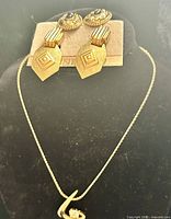 Necklace displayed with both clip-on earrings