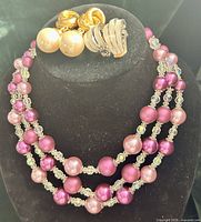 Necklace on bust with both pairs of clip-on earrings displayed