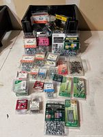 Overall view showing all packaged fasteners in crate and on table