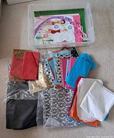 Clear tote containing assorted tissue paper packs and loose sheets