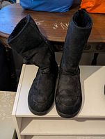 Front view of both black Ugg boots standing upright