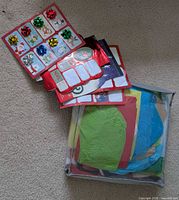 Sheets of Christmas sticker gift tags with metallic bows and bag of assorted tissue paper