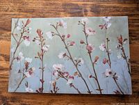 Full view of floral canvas print on wood surface