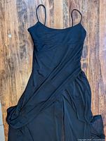 Full view of jumpsuit laid flat showing chiffon overlay and wide-leg design