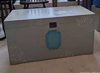 Front view showing chest color, plaque, latch and stenciled designs