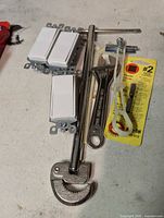 Overall view of switches, wrench, pipe cutter, driver bit package, extension bar, toggle bolt, zip tie