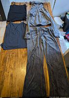 Full set laid out: hoodie, pants, two tank tops