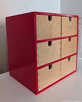 Three-quarter left view of red wooden drawer unit