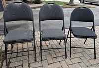 Front view of three padded folding chairs set up side-by-side