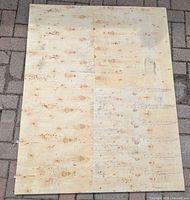 Full view of plywood sheet on paving stone ground