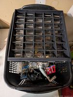 Organizer resting on laundry basket with loose hardware visible
