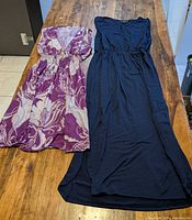 Both dresses laid flat showing full lengths and styles