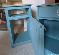 Nightstand interiors showing open door and shelf